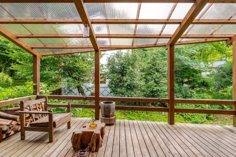 The covered deck above the stream