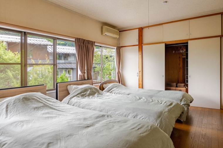 Three single beds beneath the windows